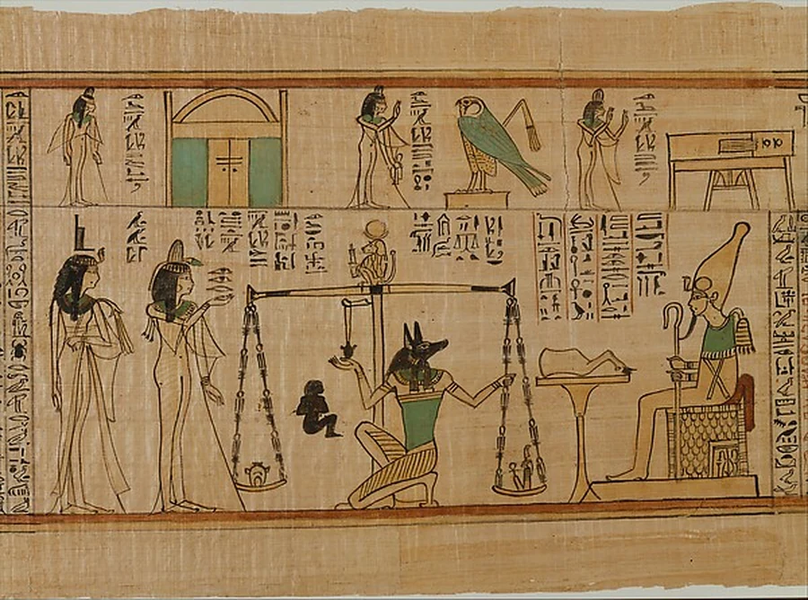 An ancient Egyptian papyrus painted with the jackal-headed god Anubis adjusting a balance scale, weighing a heart against a feather, watched by figures on either side.